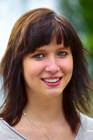 Portrait of a young  woman in background a fountain, outdoor in a small city Dillingen, Saarland / Germanyの写真素材