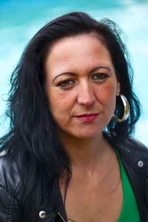 Portrait of a mid adult woman in background a fountain, outdoor in a small city Dillingen, Saarland / Germanyの写真素材