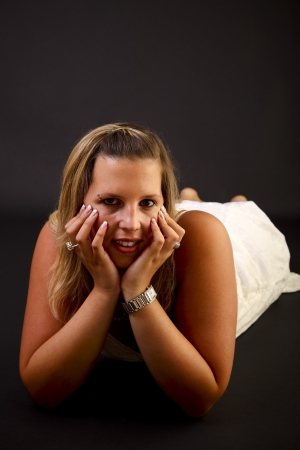 Young blond woman on black background, studio shot  の写真素材