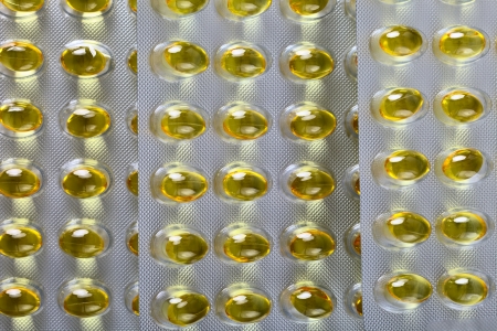 Close up of a pill blister with yellow pills の写真素材