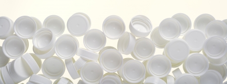 Close up of a pastic lids ( from milk container ) isolated on white, as a background