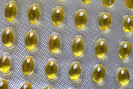 Close up of a pill blister with yellow pills の写真素材