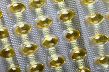 Close up of a pill blister with yellow pills の写真素材