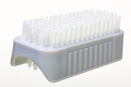 Close up of a small nail brush, isolated on white backgroundの写真素材