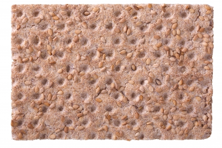 Close up of a crispbread with sesame seeds isolated on white, selective focusの写真素材