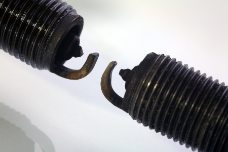 Close up of a old spark plugs  with carbon deposit isolated on white backgroundの写真素材