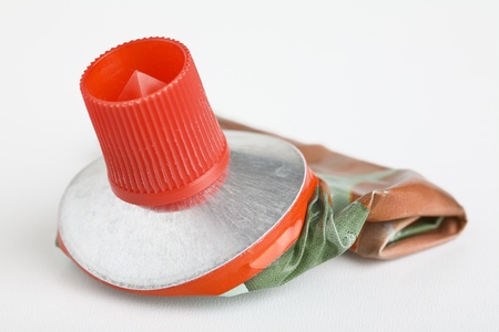 Close up of old empty metal tube(tomatoe paste), isolated on  white background.の写真素材