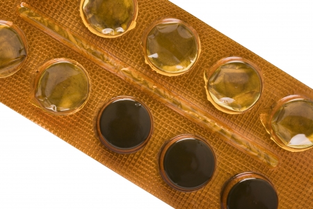 Close up of a half empty pill blister ( with carbo medicinalis pills) isolated on whiteの写真素材