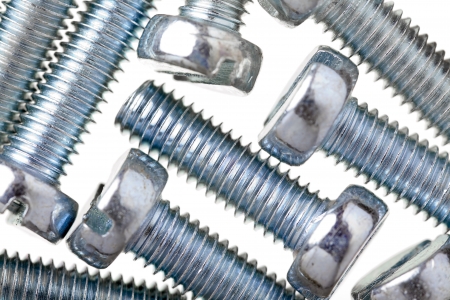 Close up of  screws zinc covered, isolated on white backgroundの写真素材