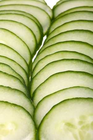 Close up of a cucumber slices isolated on white backgroundの写真素材
