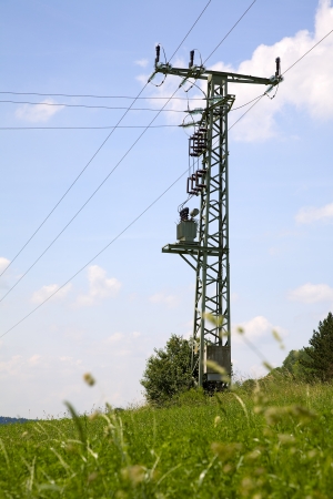 Power line and a electricity pylon with transformer, summer, Saarland/Germanyの写真素材