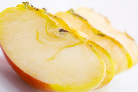 Close up of a quarters of apple fruit, isolated on white backgroundの写真素材