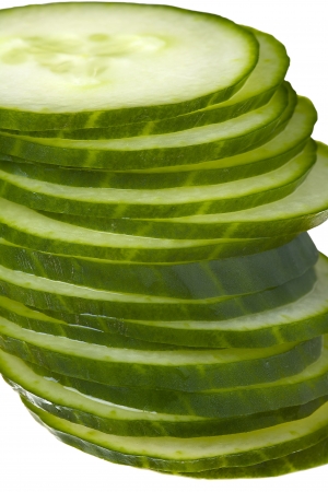 Close up of a cucumber slices isolated on white backgroundの写真素材