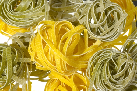 A raw colored pasta isolated on white backgroundの写真素材