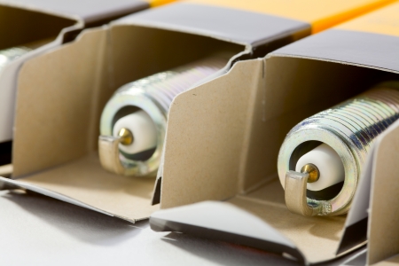 Close up of a spark plugs in a cardboard box on white backgroundの写真素材