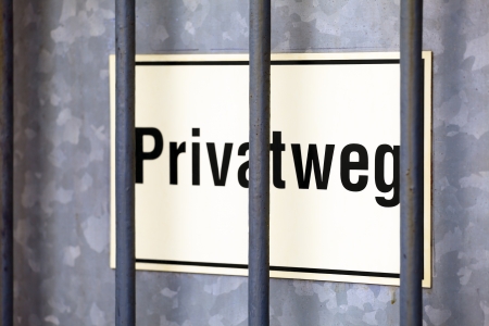 A plate with  the text Privatweg (privat way) on garden door, small city Saarburg, Rheinland-Pfalz, Germanyの写真素材