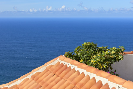 View of Atlantic over tiled roof, city La Puntilla, Canatry Islands, Spain.の写真素材