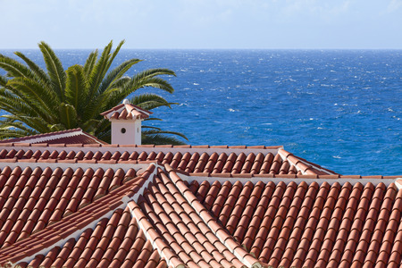 View of Atlantic over tiled roof, city Costa Adeje, Canatry Islands, Spain.の写真素材