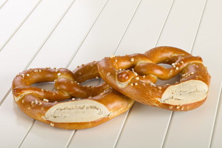 A pretzel is a type of baked bread product made from dough most commonly shaped into a knot.の写真素材