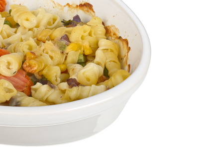 Pasta with cheese gratain in an oval dish isolated on white background.の写真素材