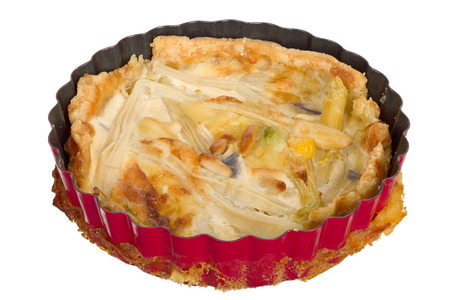 Handmade quiche in a small baking dish isolated on white background.の写真素材