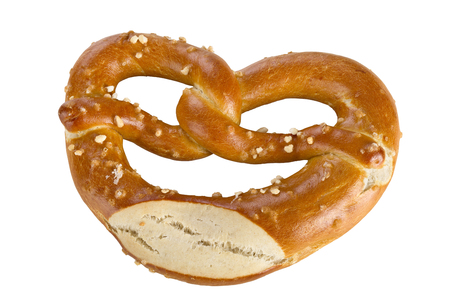 A pretzel is a type of baked bread product made from dough most commonly shaped into a knot, isolated on white background.の写真素材