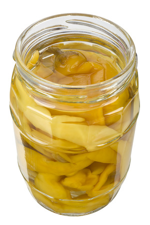 The yellow pepper in open jar isolated on white background, focus stacking.の写真素材