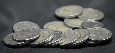 5 and 10 THB Coins on black background.
