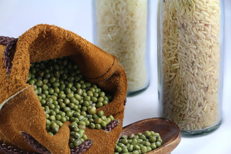 green bean in the leather bag and a spoon on white background.の写真素材