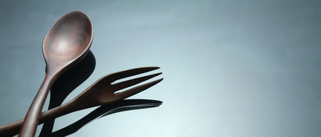 Two wood spoon on the table in low key lighting style.の写真素材