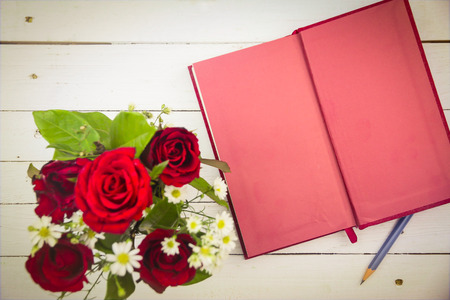 red roses and red diary on white wooden background with copy space. vintage style.の写真素材
