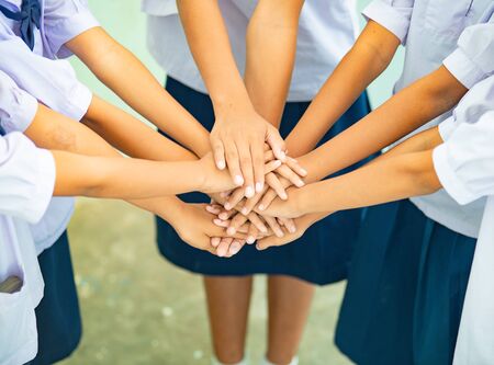 They put hand to hand to show cooperation.の写真素材