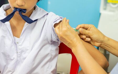 The doctor vaccinated the students, injected arms, students have painの写真素材