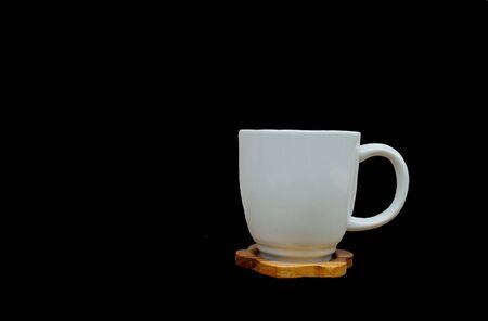 A white cup of coffee on a black backgroundの写真素材