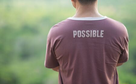 A man wearing a T-shirt with the words "possible"の写真素材