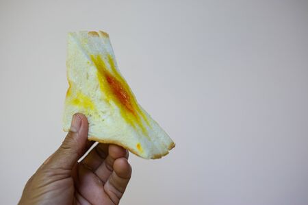 A hand holding a sandwichの写真素材