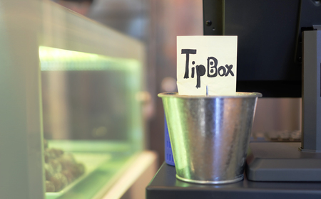 Tin tip box with yellow paper on counterの写真素材