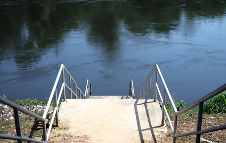 Step of ladder near watersideの写真素材