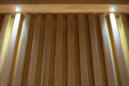 Wooden wall decoration with two lightingの写真素材
