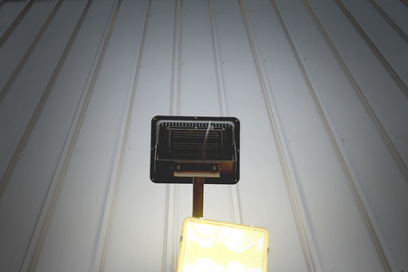 Spotlight shines up on metal wallの写真素材