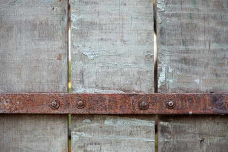 Rusted steel rod attached to the wooden plate, backgroundの写真素材