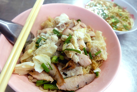 Noodle Pork Crab Dumplings in Pink Plastic Bowl With chopsticks and spoonの写真素材