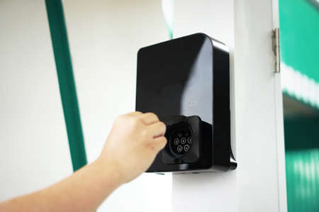 AC Normal Charger for Electric Vehicle use Green Energy, on white pole