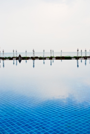 White umbrella and ground of swimming pool のeditorial素材