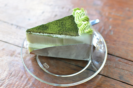 Green tea cake on wood tableの写真素材
