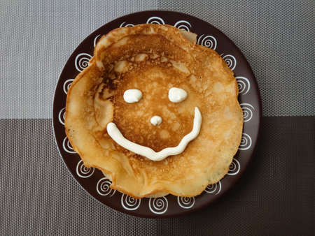 Appetizing pancakes on a plate. Homemade thin crepes for breakfast or dessertの写真素材