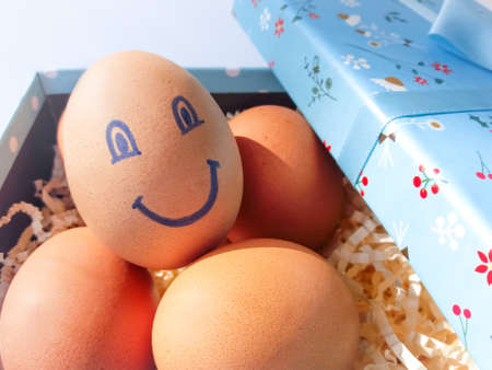 Happy easter! Close-up of Easter eggs with a smile in a box. Easter eggs in a gift boxの写真素材