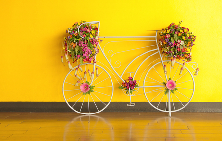 bicycle and flower decorated at yellow wall.の写真素材