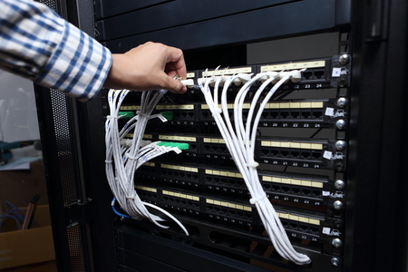 young engeneer business man with thin modern aluminium laptop in network server roomのeditorial素材