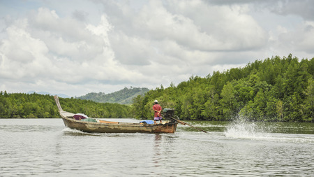 Fisherman on the boat at nakornsrithumarat thailandの写真素材